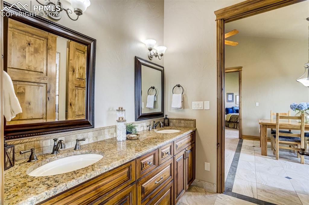 East Wing Bathroom 1 offers a double vanity and zero-clearance shower, with easy access to the central lounge—an ideal layout for aging in place or accessible living