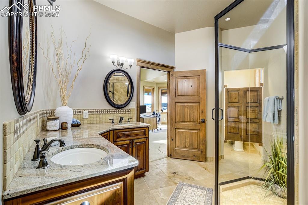 The west wing pass-through bath offers convenient access for both the bedroom and adjacent living space, combining privacy with practical functionality for guests or extended stays