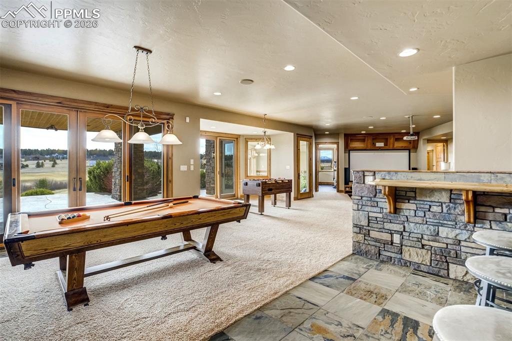 Designed for gathering and play, the recreation room offers generous space for games, casual lounging, and the kind of moments that bring everyone together