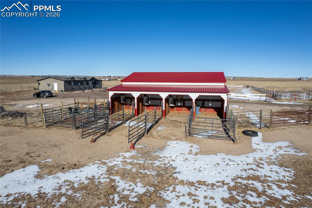 Horse barn featuring a view of rural / pastoral area