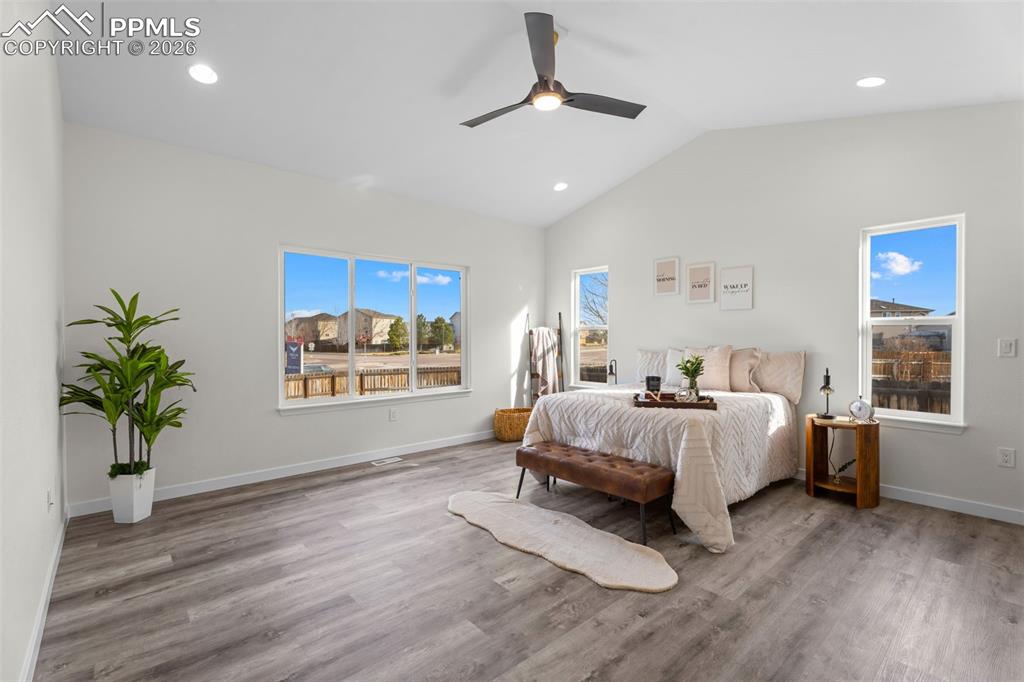 Bedroom featuring lofted ceiling, wood finished floors, ceiling fan, and recessed lighting