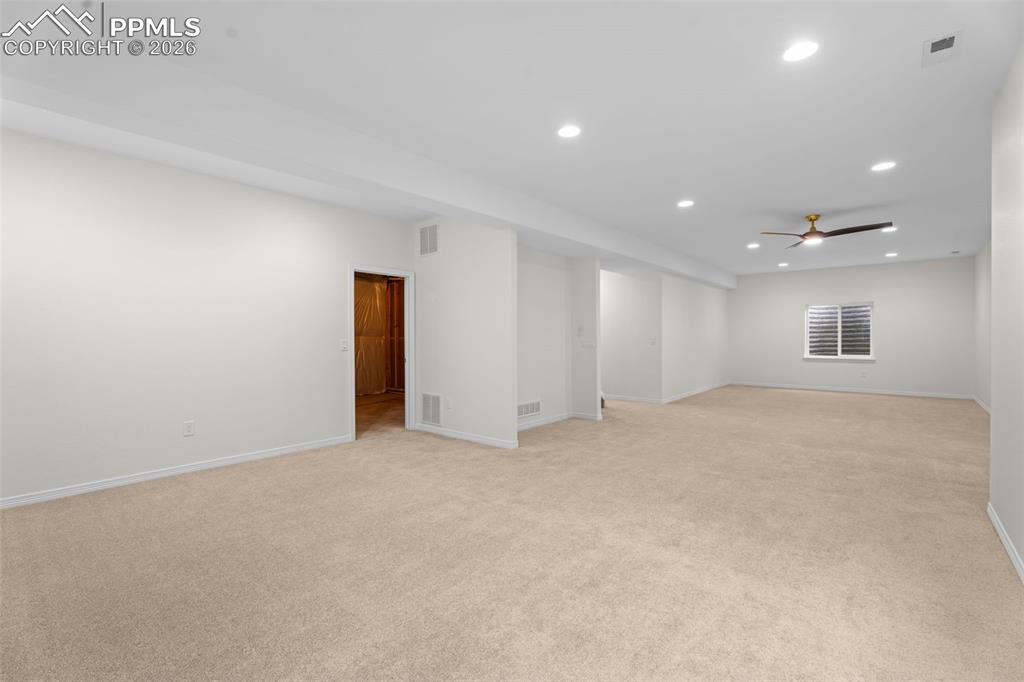 Spare room featuring a ceiling fan, light colored carpet, and recessed lighting