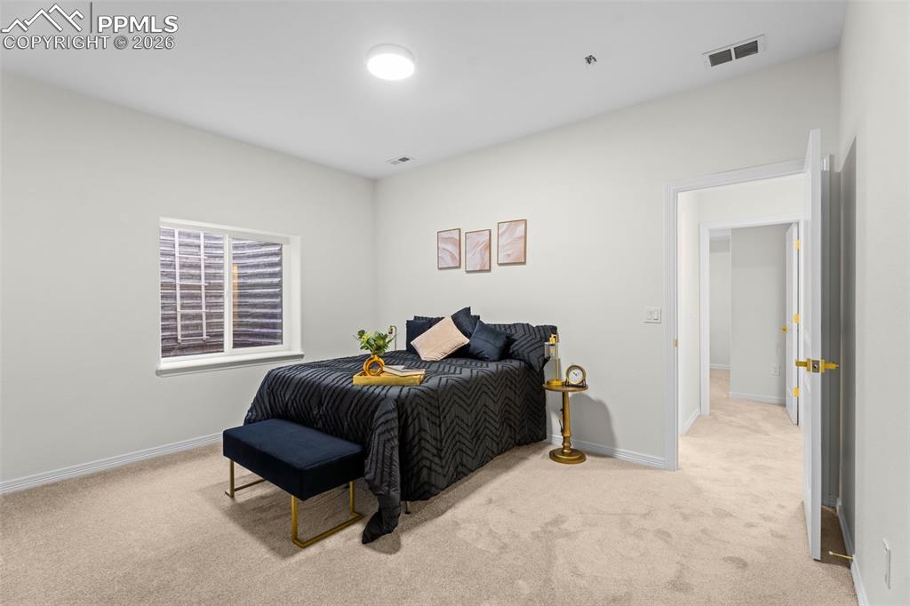 Bedroom with light carpet and baseboards