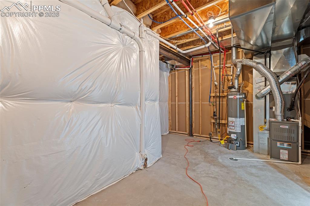 Unfinished basement featuring water heater and heating unit