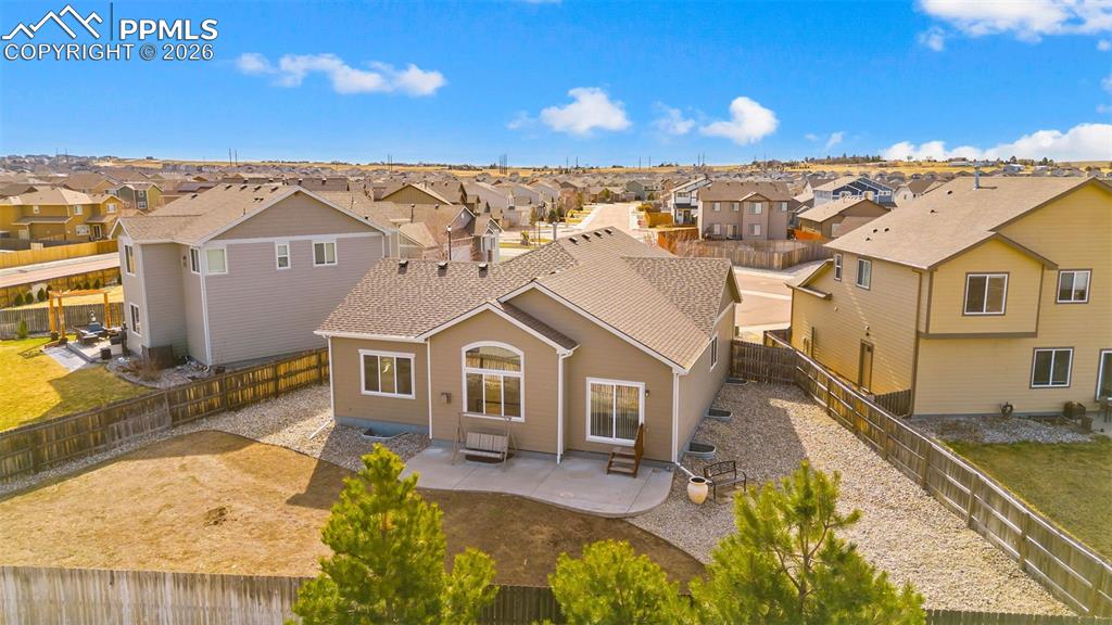 Back of house with a patio, a residential view, and a fenced backyard