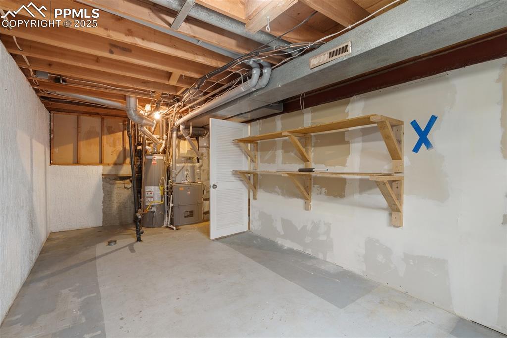 Utility room featuring a furnace unit and a water heater