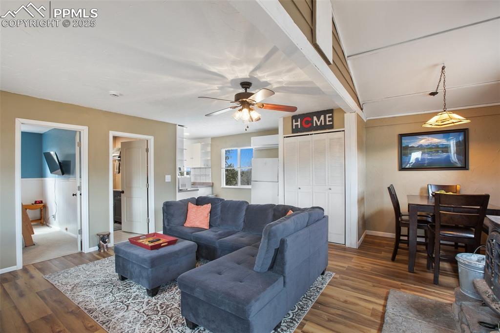 Living area with wood finished floors and ceiling fan