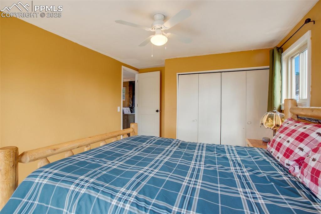 Bedroom featuring ceiling fan and a closet