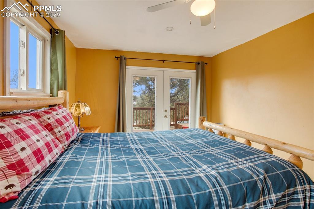 Bedroom featuring access to outside, a ceiling fan, and french doors