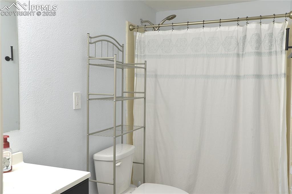 The lower level shared bath is just off the fourth bedroom.