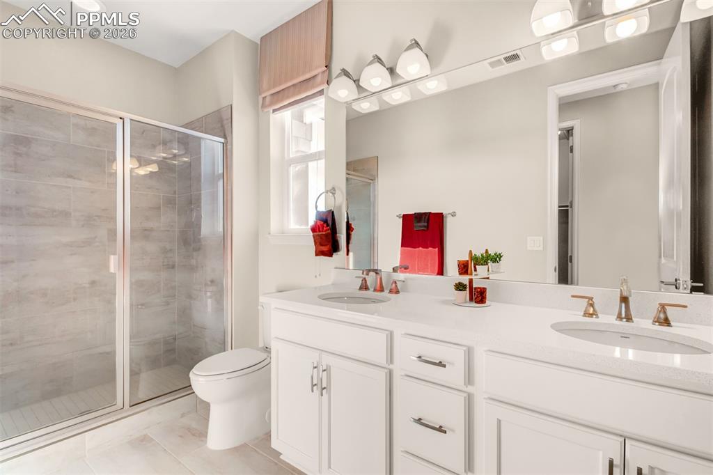 Primary bathroom with dual vanity and free standing shower