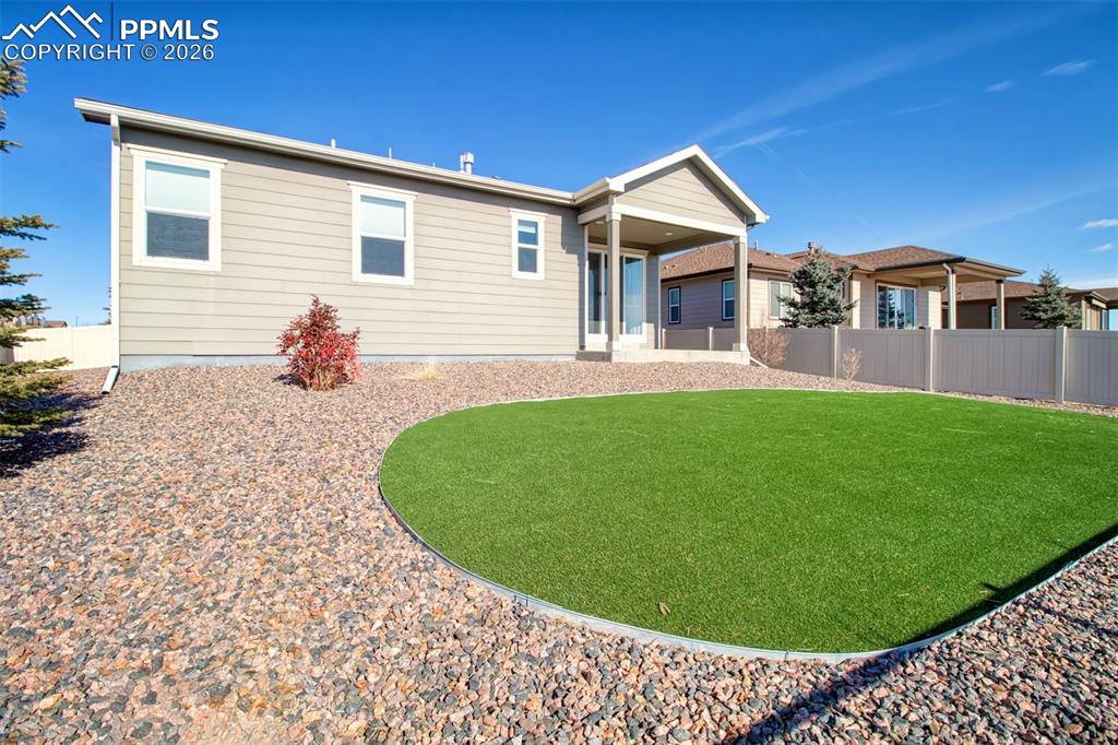 Large backyard with astroturf grass for low maintenance and full enjoyment