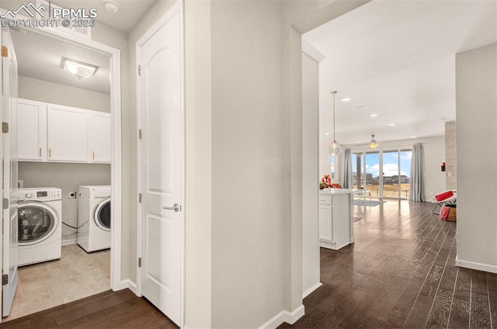 Enter the home and notice the laundry room and front bedroom to the left