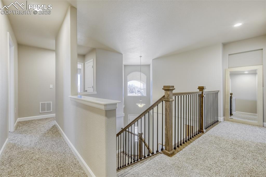 stairs to upper level bedrooms and laundry room
