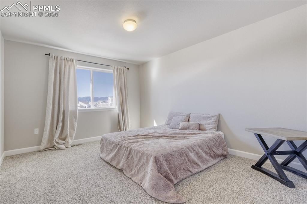 upper level second bedroom with views of the mountains