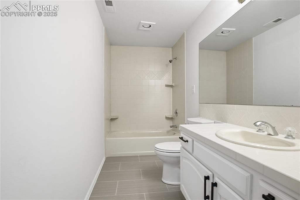 Bathroom featuring vanity and  shower combination