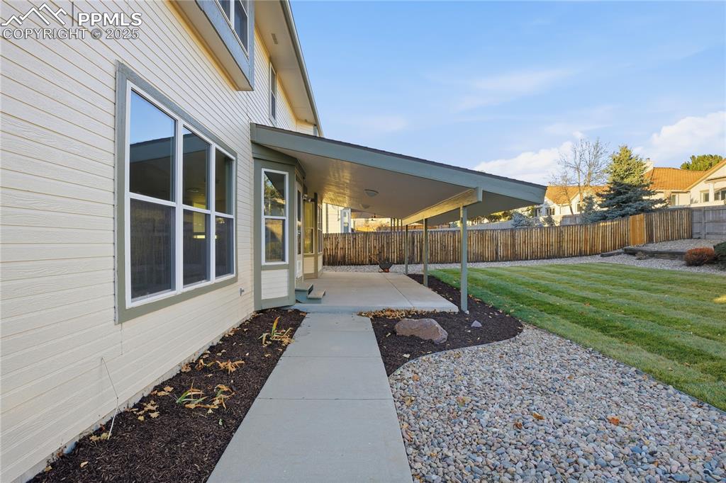 Fenced backyard with a patio