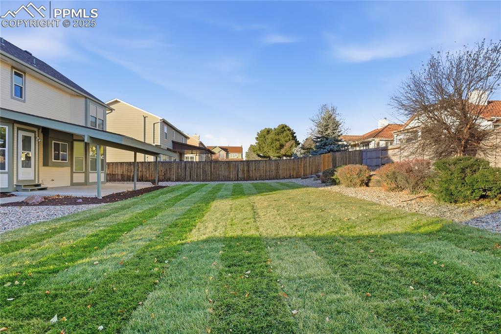 Fenced backyard with a patio and a residential view