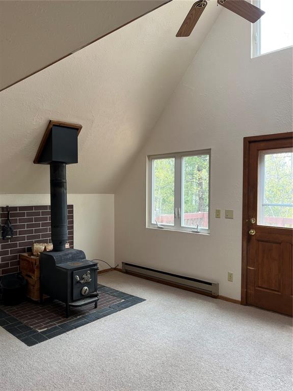 Vaulted Ceilings and lots of windows give you that GREAT room vibe and some passive solar heat!  Also has a great wood stove to take the chill off!