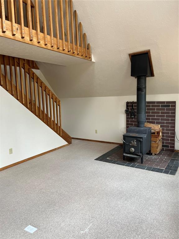 Stairs in living room lead up to sleeping loft with little sitting or ? area at top of stairs