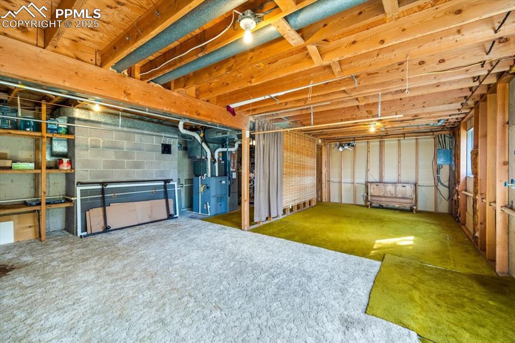 Unfinished basement featuring heating unit