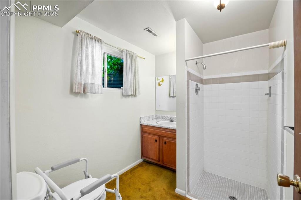 Bathroom with vanity and a stall shower