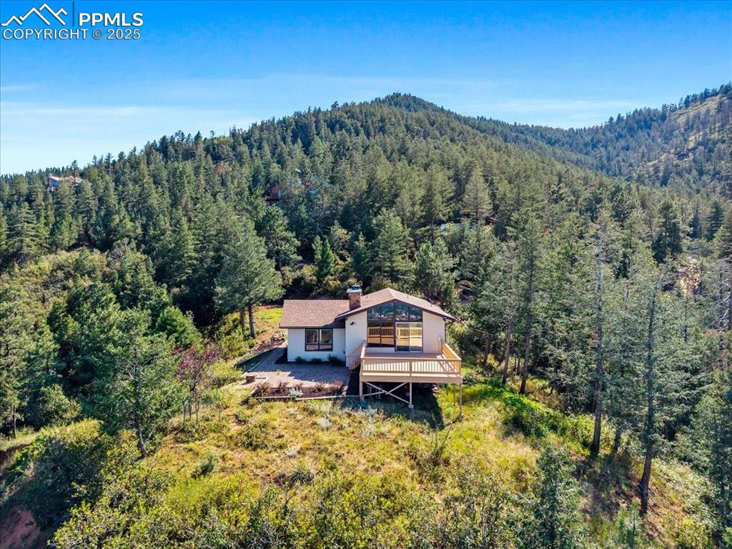 View of subject property featuring a heavily wooded area