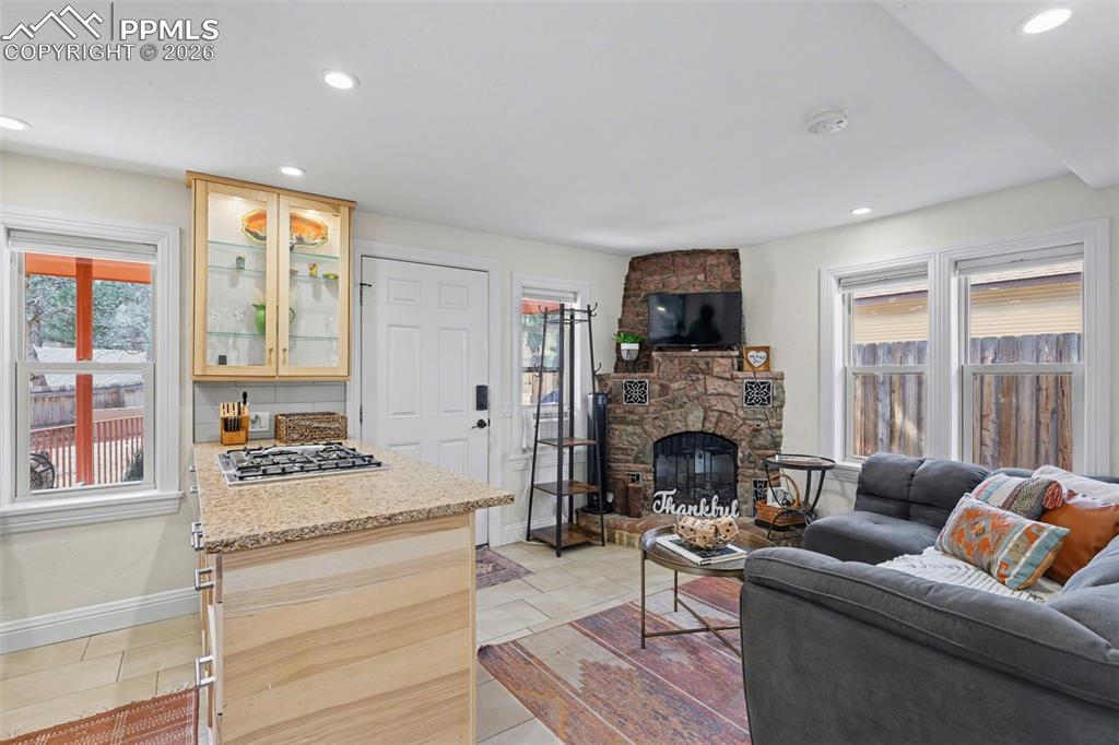 The living room features an electric fireplace to cozy up next to and windows for natural lighting!