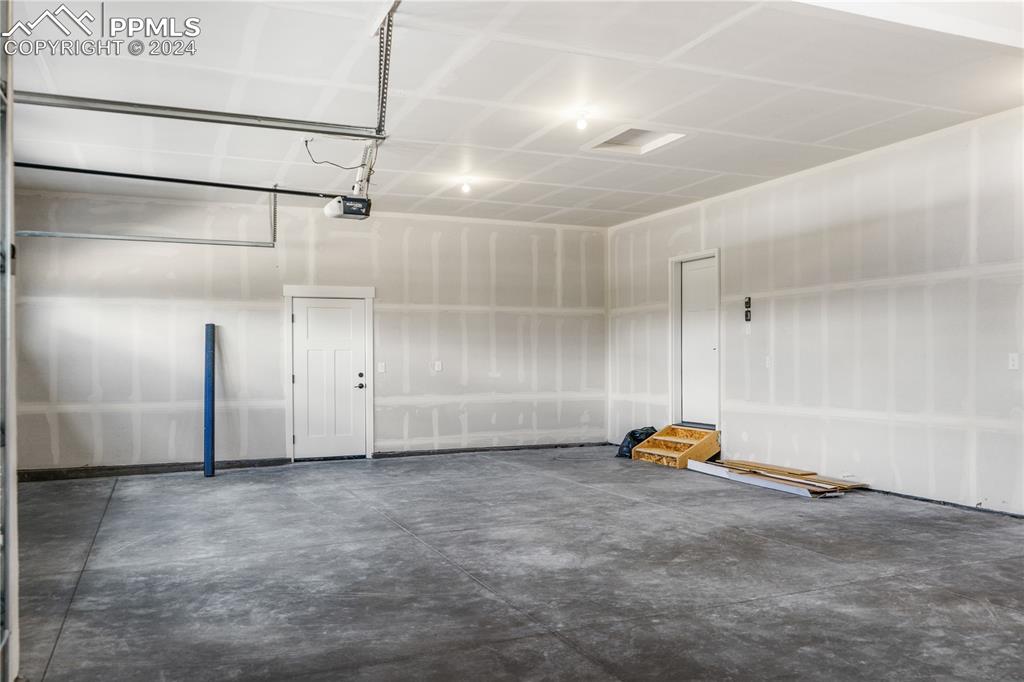 Garage featuring a garage door opener