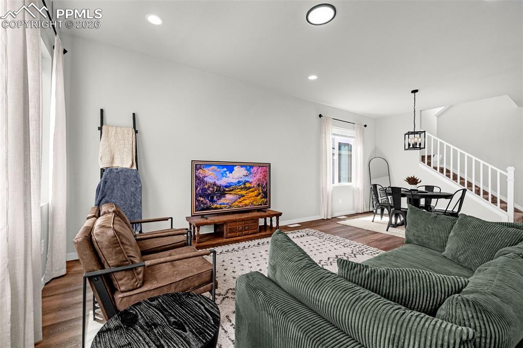 Living room featuring great natural light, luxury vinyl plank flooring and upgraded fixtures