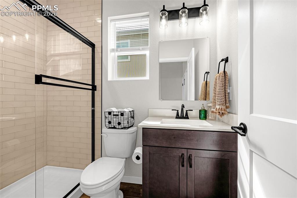 Main level full bathroom with a granite vanity  and a large walk in shower 