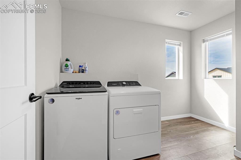 Huge laundry room with windows; great natural light, plenty of room for storage, and on the same level as the primary and two additional bedrooms 
