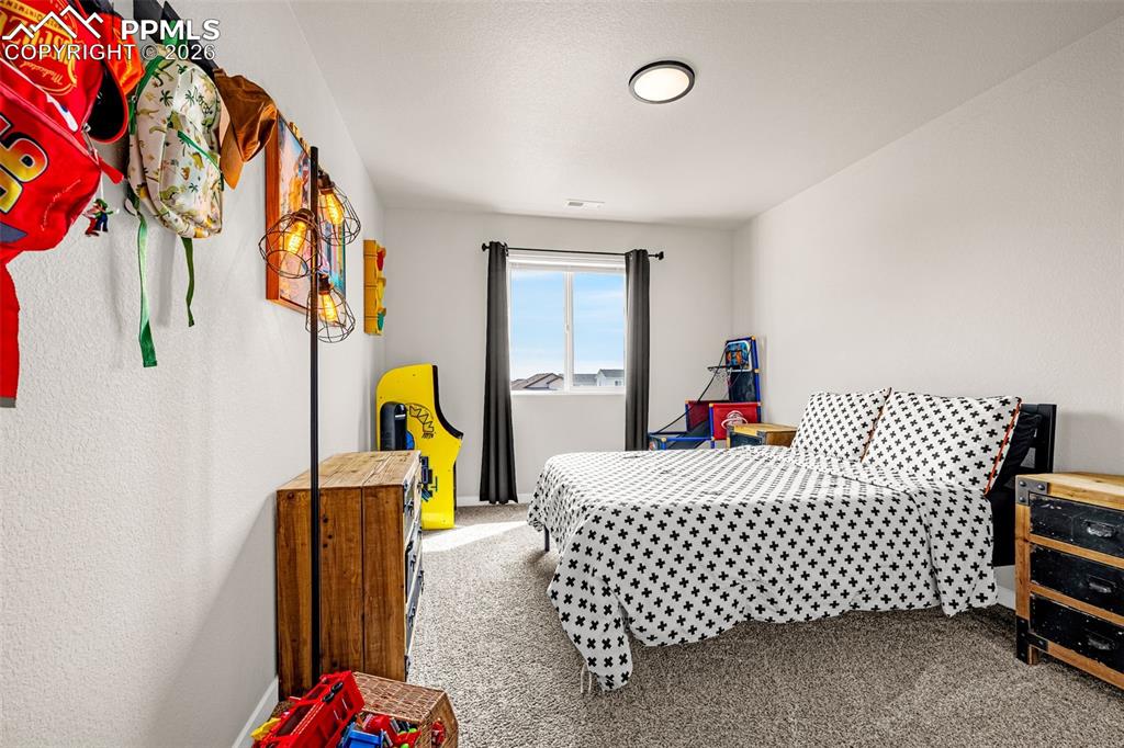 Third spacious bedroom on the upper level with fresh clean carpet, great natural light, and sizable closet