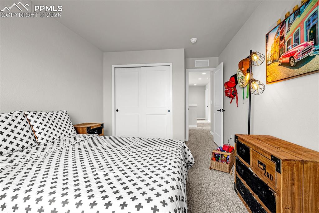 Third spacious bedroom on the upper level with fresh clean carpet, great natural light, and sizable closet 
