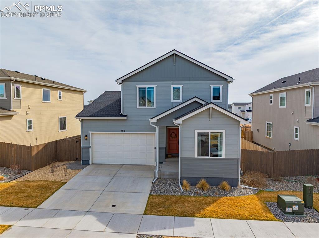 View of front of house with concrete driveway, with 3-car attached tandem garage