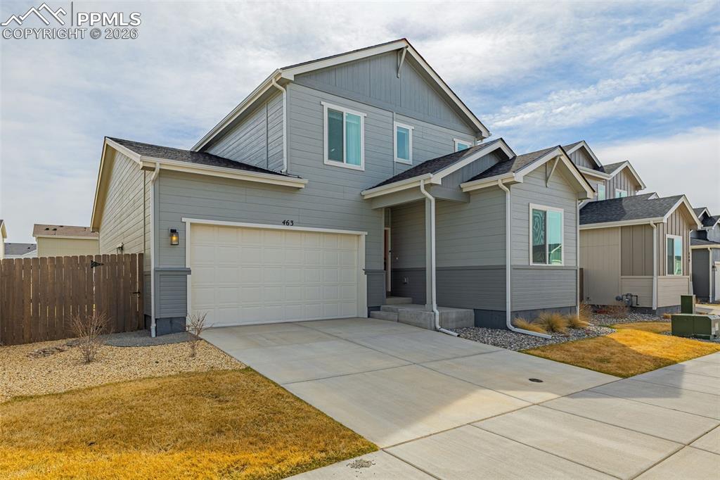 View of front of house with concrete driveway, with 3-car attached tandem garage