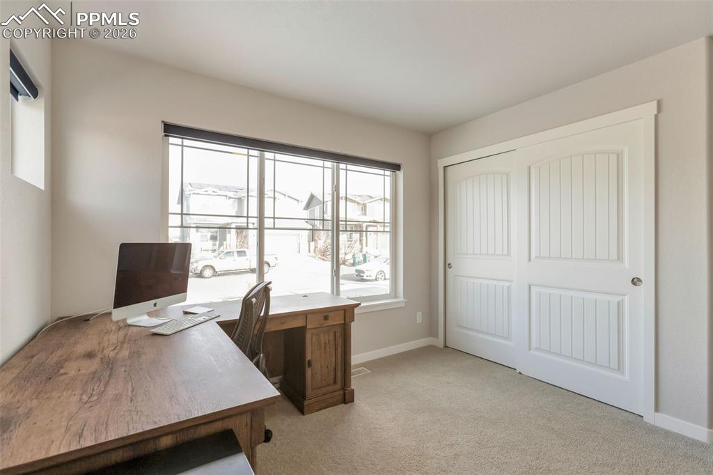 Bedroom #2 Main Level with light colored carpet and plenty of natural light