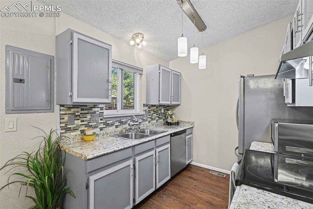 Kitchen with window above sink that looks out to back decking