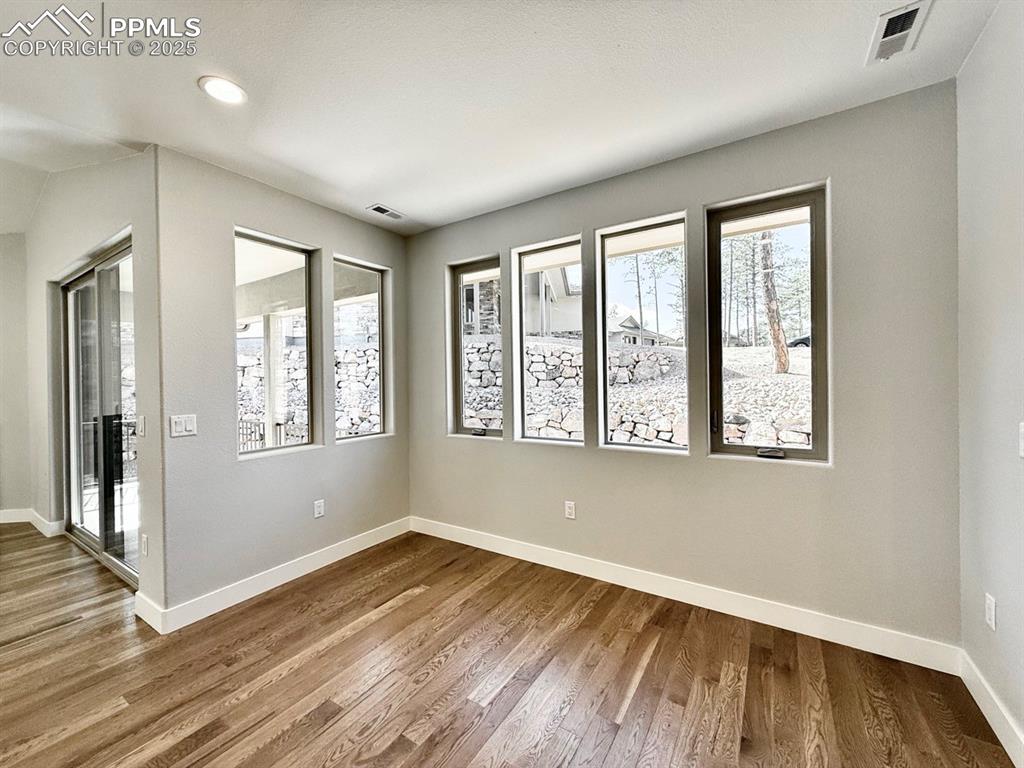 Dining Room with Wood Flooring and Large Windows.