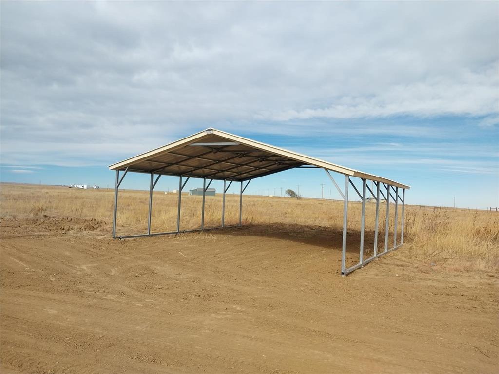 View of home's community featuring a carport and a view of rural / pastoral area
