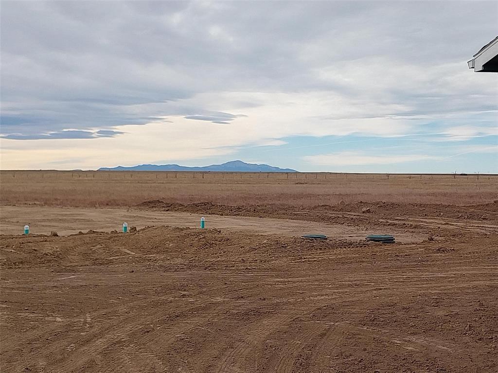 View of mountain backdrop featuring rural landscape