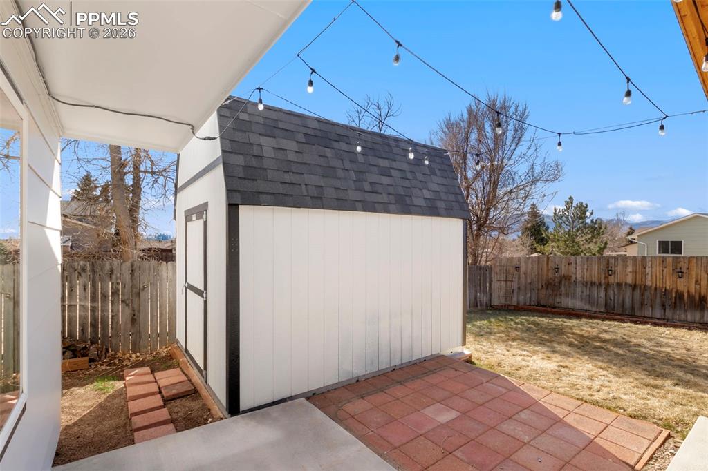 Fenced backyard with a storage shed 