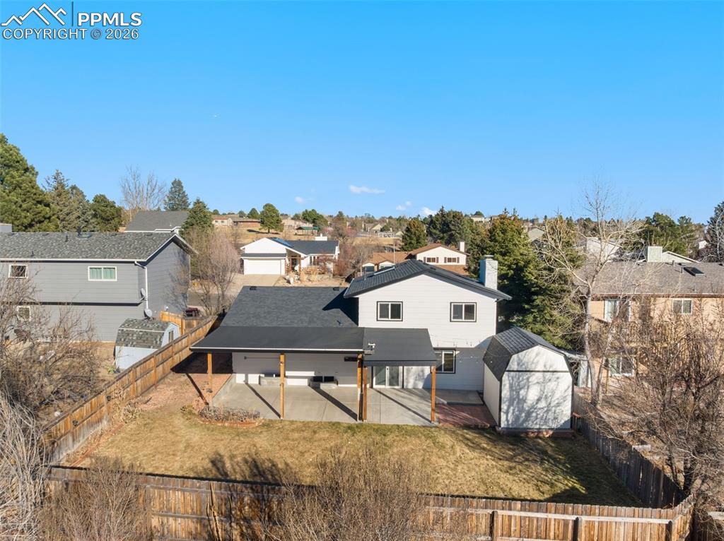 Back of house featuring a patio area, a fenced backyard, and a residential view