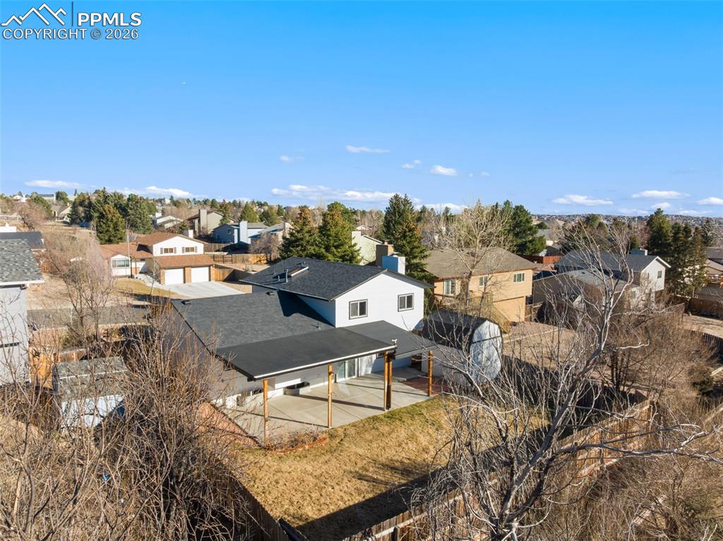 Aerial perspective of rear of home and yard