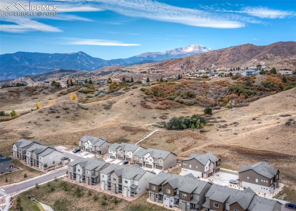 Aerial perspective of suburban area featuring a mountain backdrop