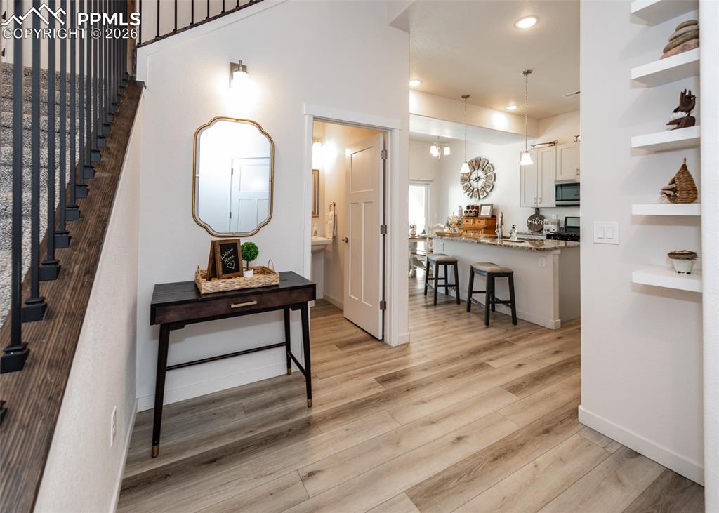 Foyer featuring light wood-style flooring and recessed lighting