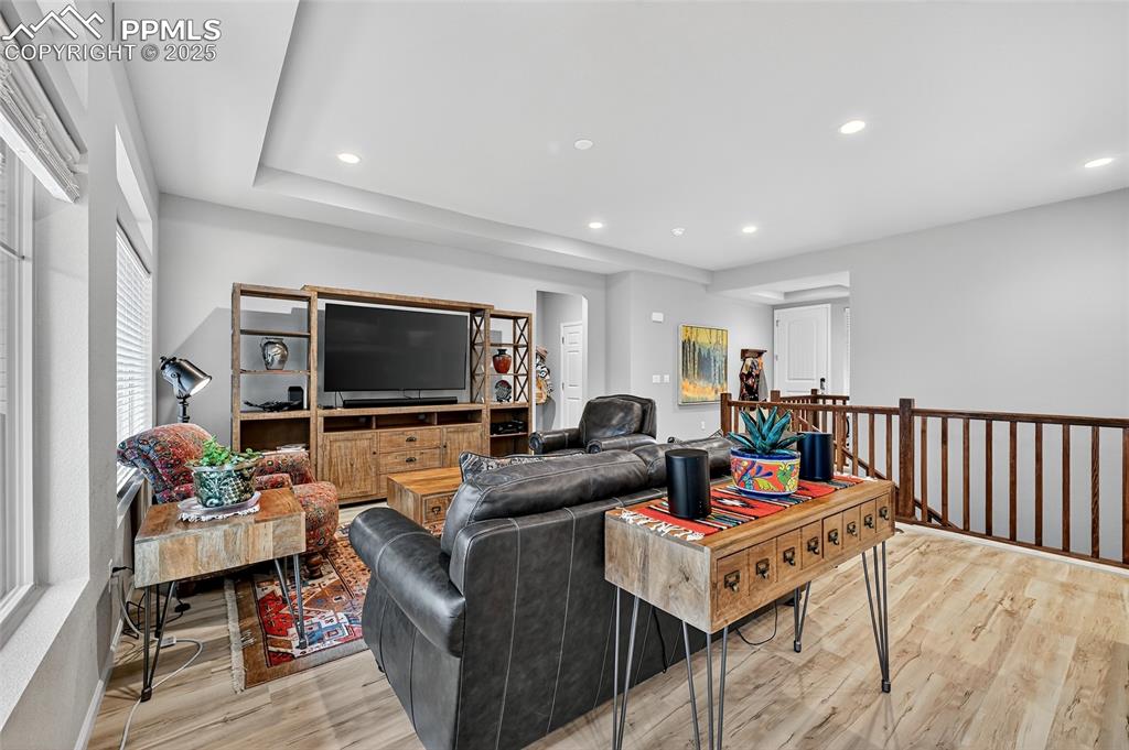 Living room with recessed lighting and light wood-style flooring