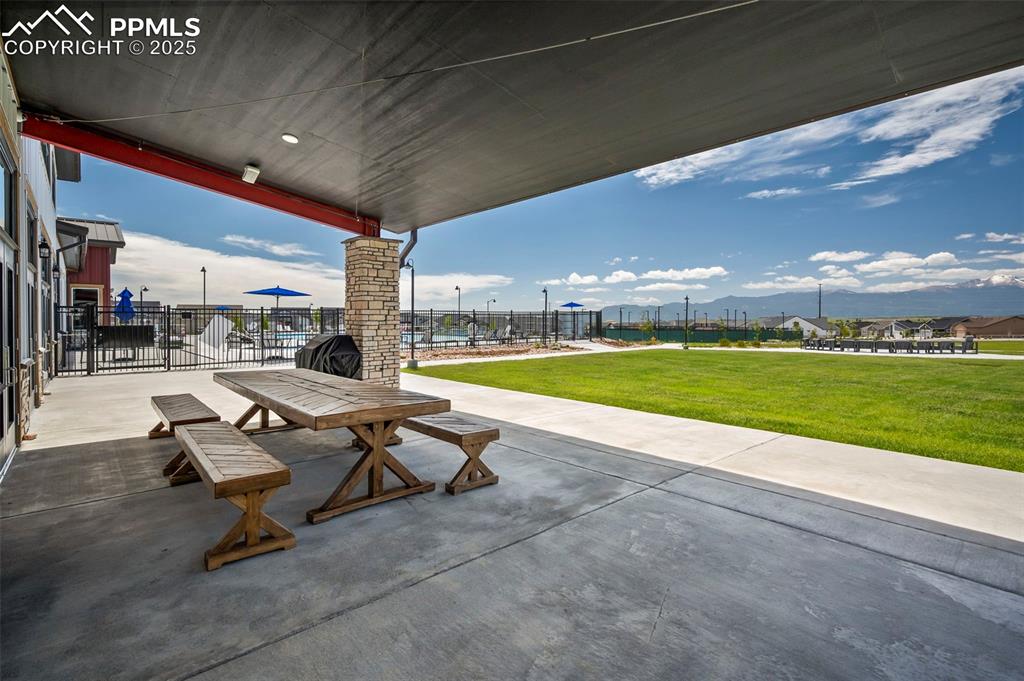 View of patio with a mountain view, area for grilling, and outdoor dining area