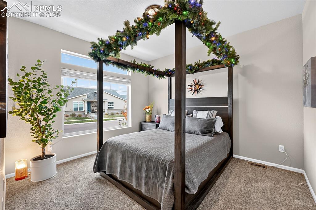 Carpeted bedroom featuring baseboards