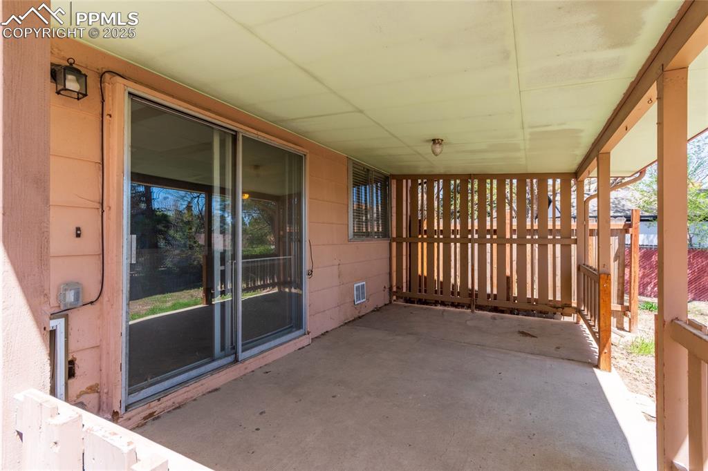 View of patio featuring fence